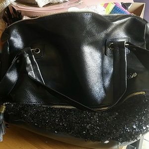 Black shoulder bag with golf and sequin accents.